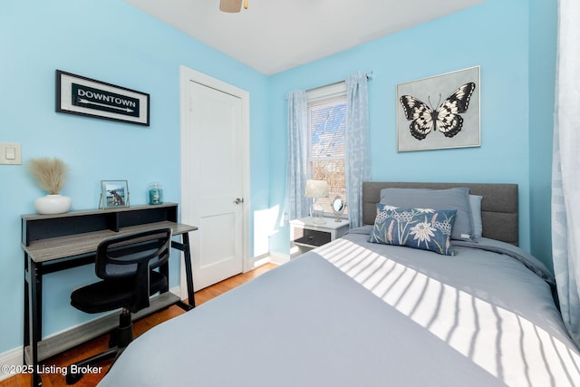 bedroom with wood-type flooring and ceiling fan