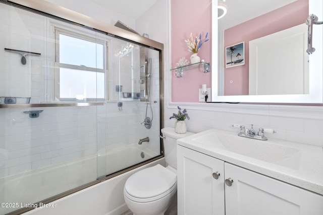 full bathroom with toilet, vanity, shower / bath combination with glass door, and decorative backsplash