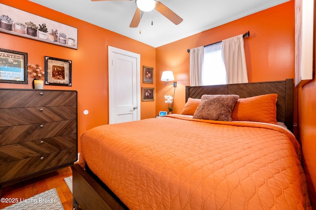 bedroom with hardwood / wood-style floors and ceiling fan