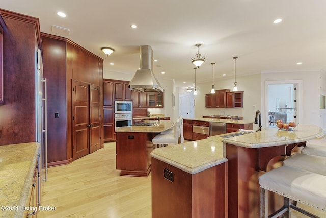 kitchen with pendant lighting, sink, stainless steel appliances, a spacious island, and island exhaust hood