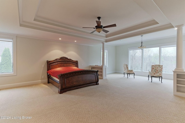 carpeted bedroom with ornate columns, crown molding, ceiling fan, and a tray ceiling