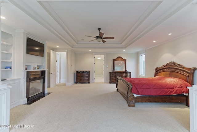 bedroom with crown molding, ceiling fan, a raised ceiling, and light carpet