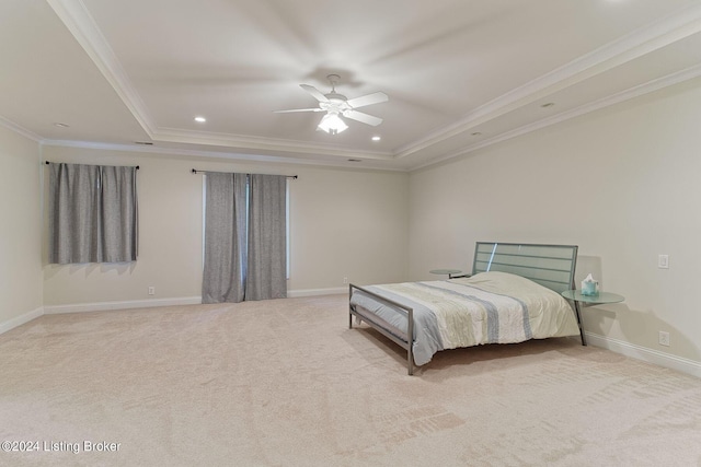 bedroom with ceiling fan, ornamental molding, a raised ceiling, and light colored carpet