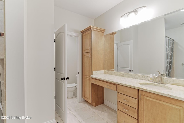 bathroom featuring tile patterned floors, toilet, and vanity