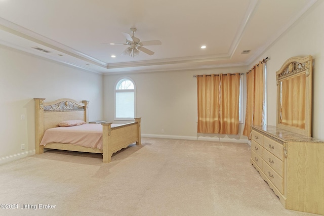 carpeted bedroom featuring crown molding, a raised ceiling, and ceiling fan