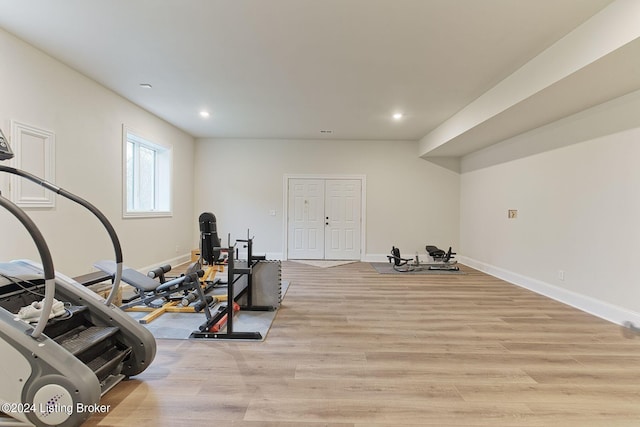 exercise room featuring light wood-type flooring