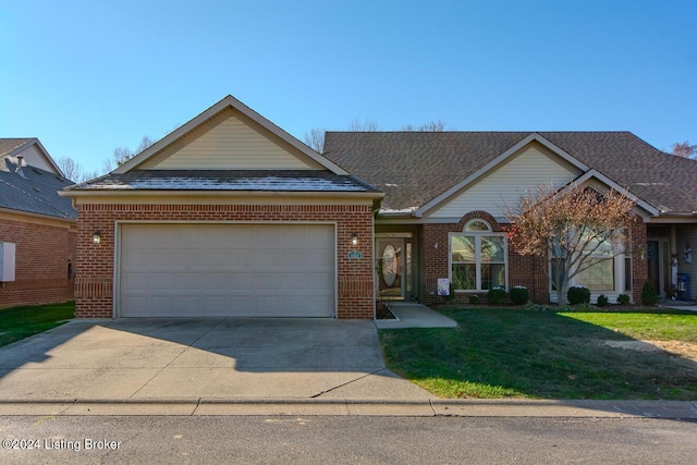 view of front facade with a garage and a front lawn