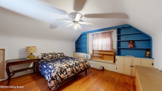 bedroom with vaulted ceiling, ceiling fan, and light wood-type flooring