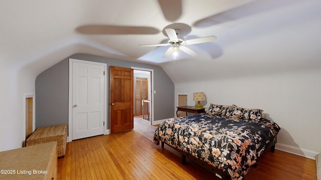 bedroom with wood-type flooring, vaulted ceiling, and ceiling fan