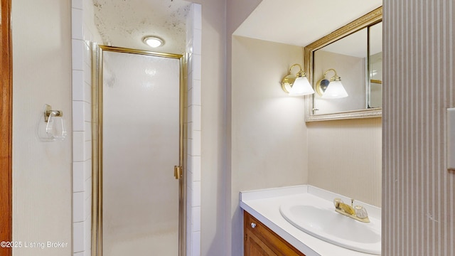 bathroom with walk in shower and vanity