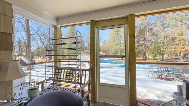 doorway to outside with crown molding and a healthy amount of sunlight