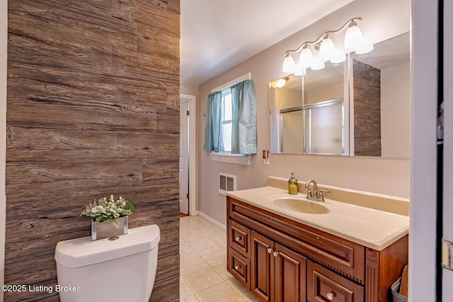 bathroom featuring an enclosed shower, vanity, tile patterned floors, and toilet