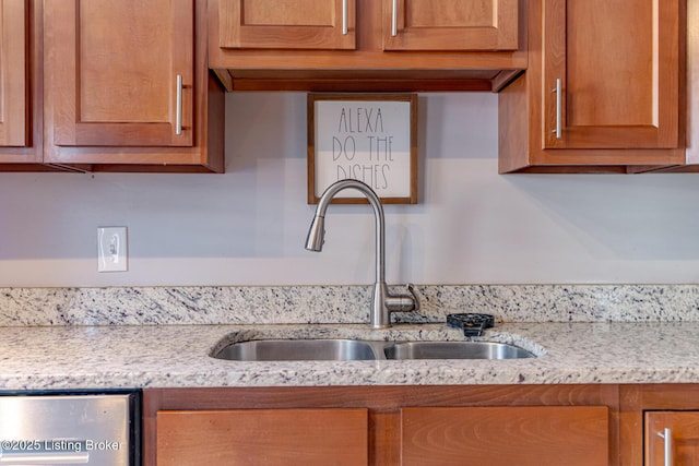 kitchen with light stone counters and sink