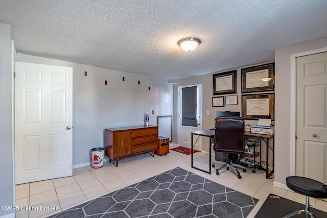 tiled office space with a textured ceiling