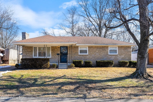 ranch-style home with a front yard and covered porch