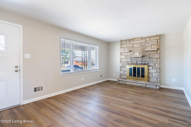 unfurnished living room featuring hardwood / wood-style flooring and a fireplace