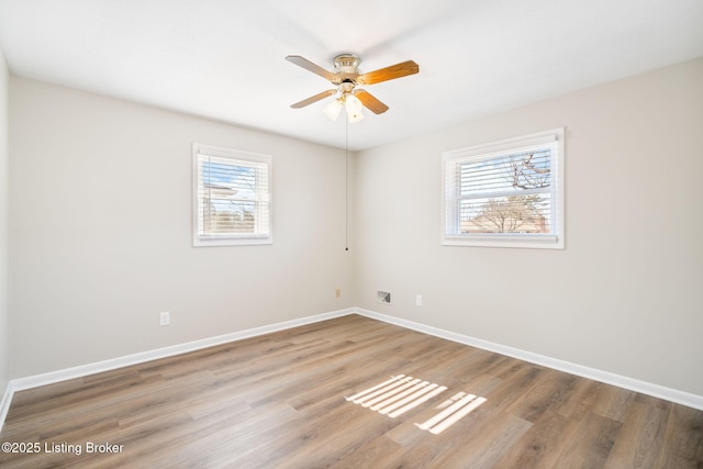 spare room featuring hardwood / wood-style floors and ceiling fan