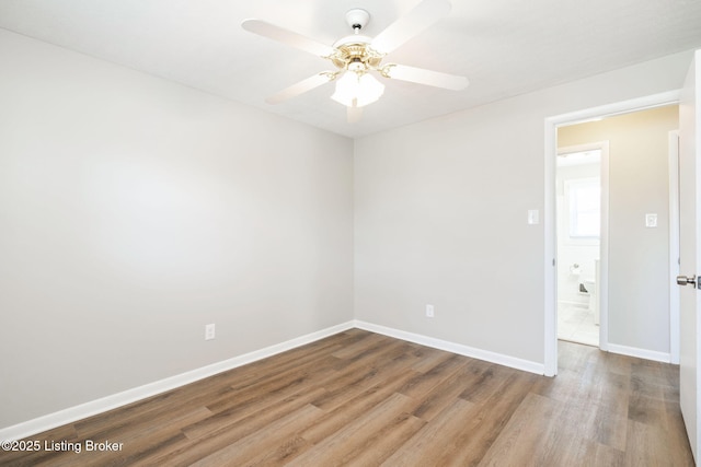 empty room with ceiling fan and hardwood / wood-style floors