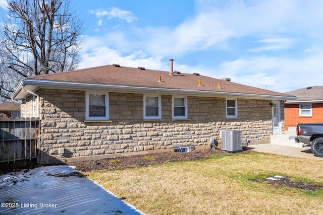 back of house featuring cooling unit and a lawn