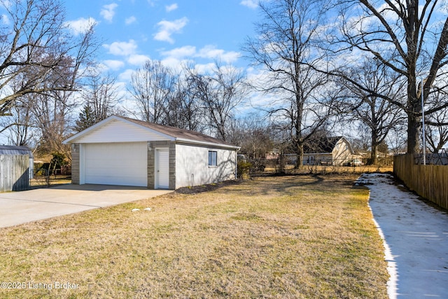 exterior space with a garage and an outbuilding