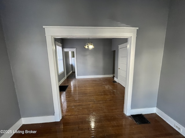 hall with dark hardwood / wood-style flooring