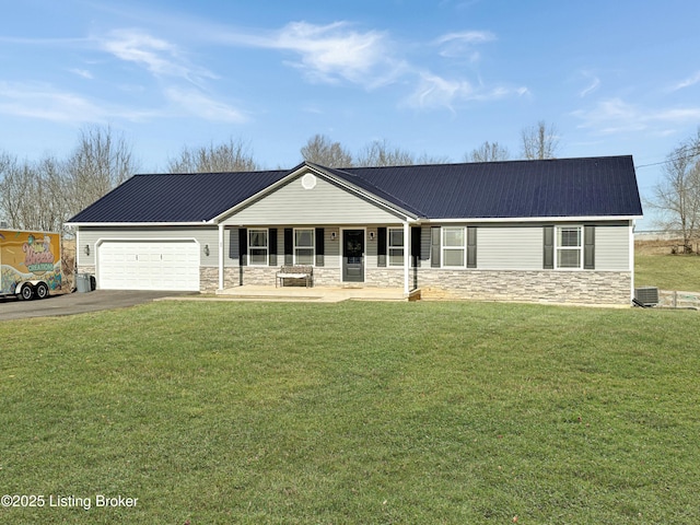 ranch-style home with a garage, central AC unit, covered porch, and a front lawn