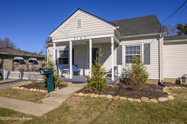 bungalow-style home with covered porch and a front lawn