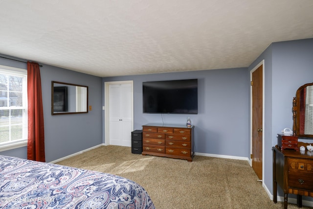 bedroom featuring carpet flooring, a textured ceiling, and a closet