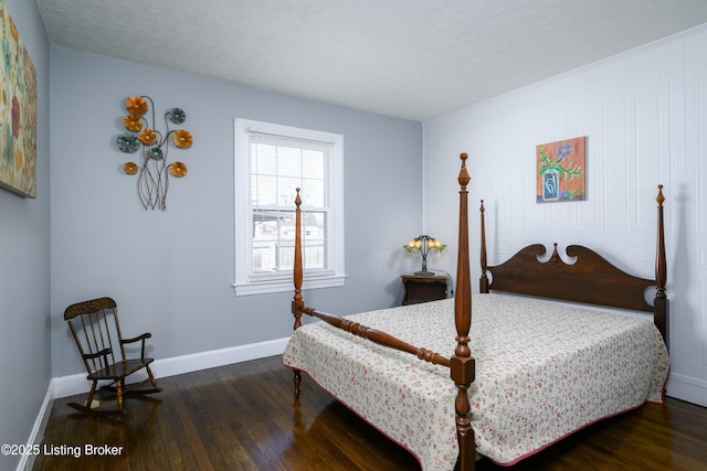 bedroom with a textured ceiling and dark hardwood / wood-style flooring