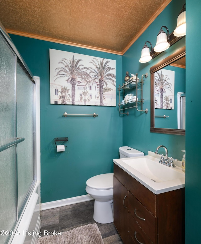 full bathroom with vanity, ornamental molding, shower / bath combination with glass door, and toilet