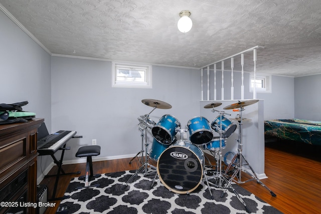 misc room with wood-type flooring and a textured ceiling