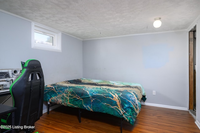 bedroom with dark hardwood / wood-style floors and a textured ceiling