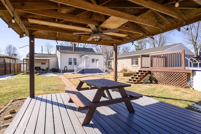 wooden deck with a yard and ceiling fan