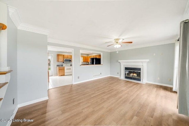 unfurnished living room featuring ornamental molding, ceiling fan, and light wood-type flooring