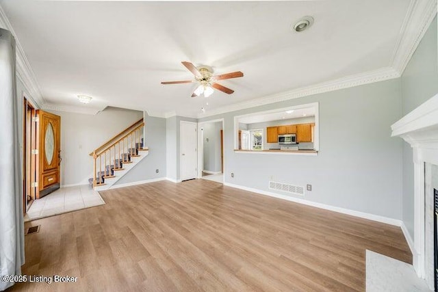 unfurnished living room with crown molding, ceiling fan, and light hardwood / wood-style flooring