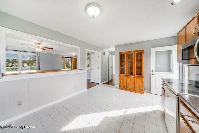 kitchen featuring light tile patterned flooring, ceiling fan, and white range with electric cooktop