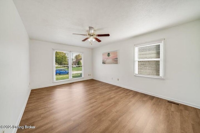 spare room featuring hardwood / wood-style floors and ceiling fan