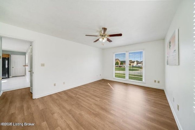 spare room with ceiling fan and light hardwood / wood-style flooring