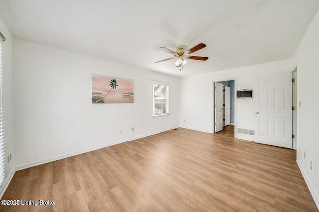 spare room with ceiling fan and light wood-type flooring