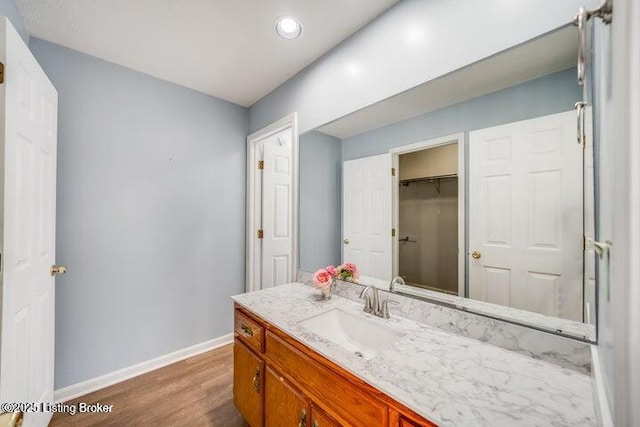 bathroom with vanity and wood-type flooring