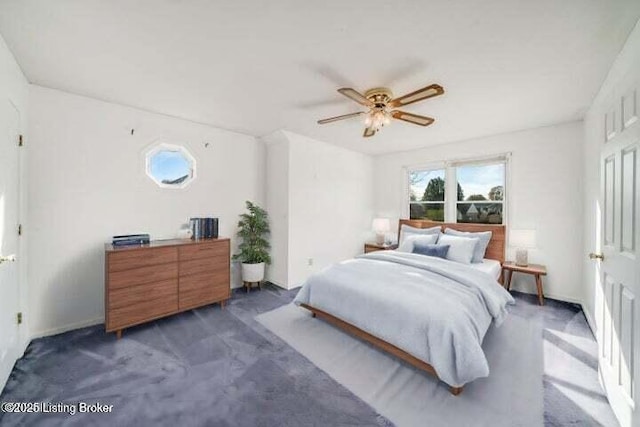 bedroom with ceiling fan and dark carpet