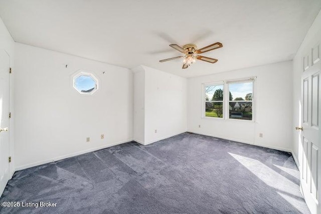 carpeted spare room with ceiling fan