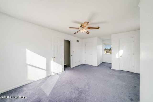 carpeted spare room with ceiling fan