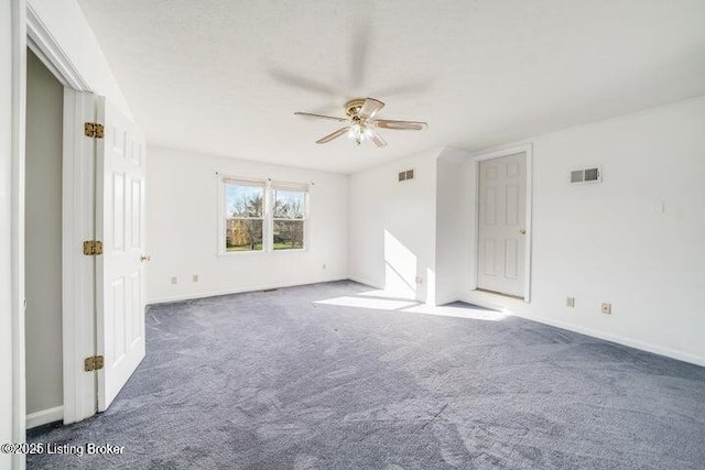 carpeted spare room featuring ceiling fan