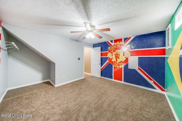 interior space featuring ceiling fan, a textured ceiling, and carpet