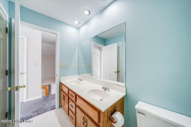 bathroom featuring vanity, tile patterned floors, and toilet