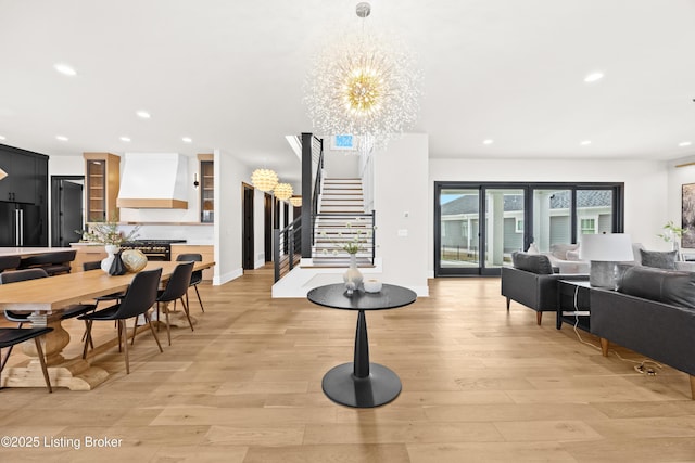 dining room with a chandelier and light hardwood / wood-style flooring