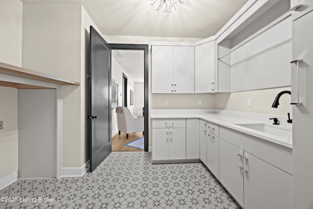 kitchen featuring sink and white cabinets