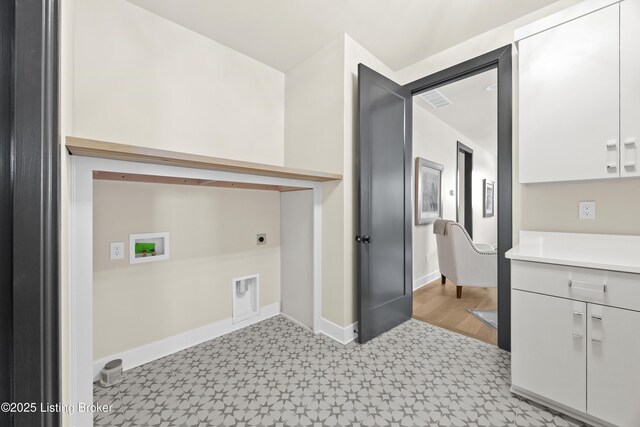 clothes washing area featuring cabinets, electric dryer hookup, and hookup for a washing machine