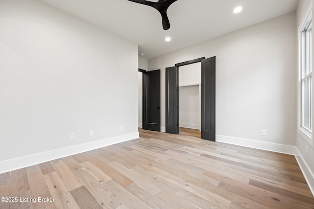 unfurnished bedroom featuring ceiling fan and light wood-type flooring